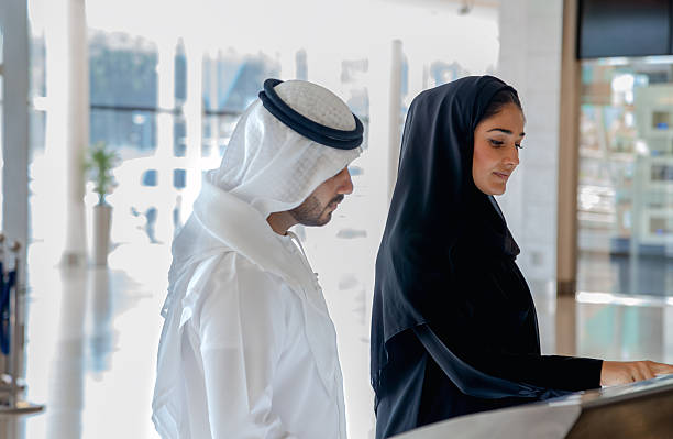 istock Modern Arab Couple Using Interactive Information Kiosk in Bright Commercial Interior 2253106818