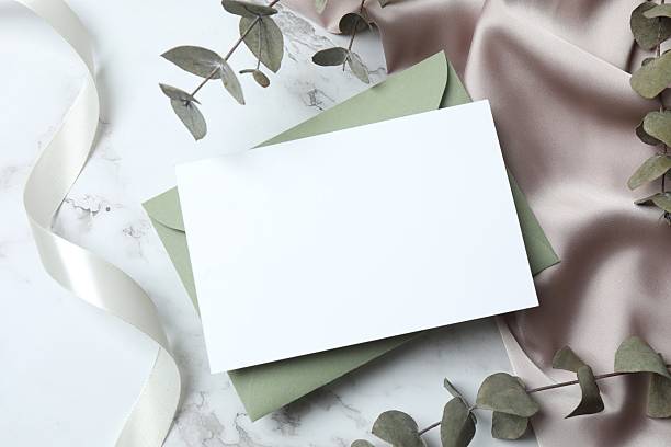 istock Romantic flat lay with paper envelope, blank card, eucalyptus branches and a ribbon on marble. Ideal for wedding invitations, event announcements, or feminine branding 2253107510