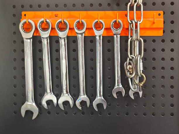 istock wrench set hanging on orange hanger over black board 2253109390