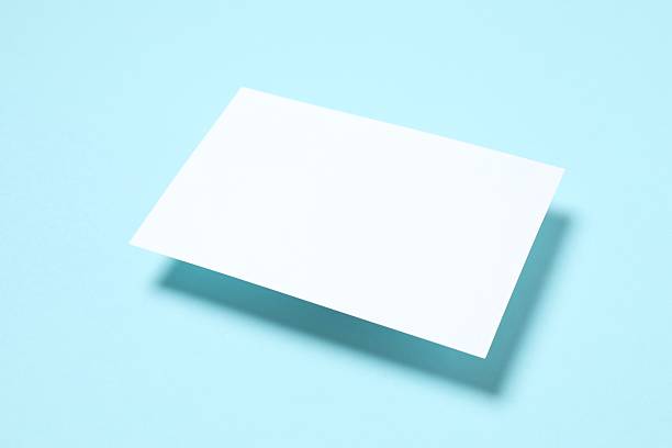 istock White paper card on blue background 2253112474