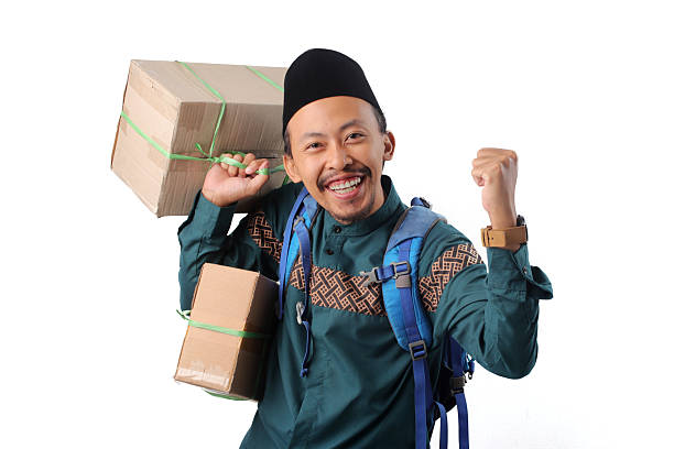istock Excited Asian Muslim Man with Backpack and Boxes Celebrating Mudik tradition 2253112672
