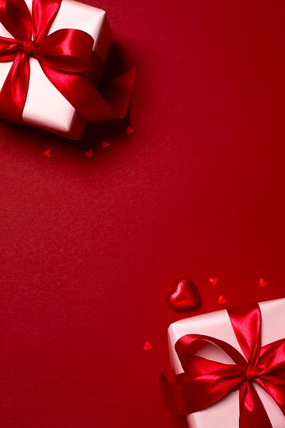 istock Gift boxes with red hearts on color background 2253112686