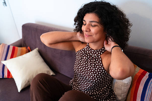 Woman massaging own neck