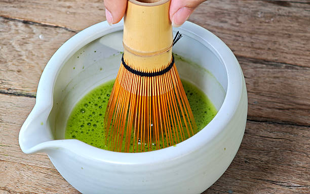istock Process making matcha green tea. Mixing matcha tea with whisk in bowl. 2253113614