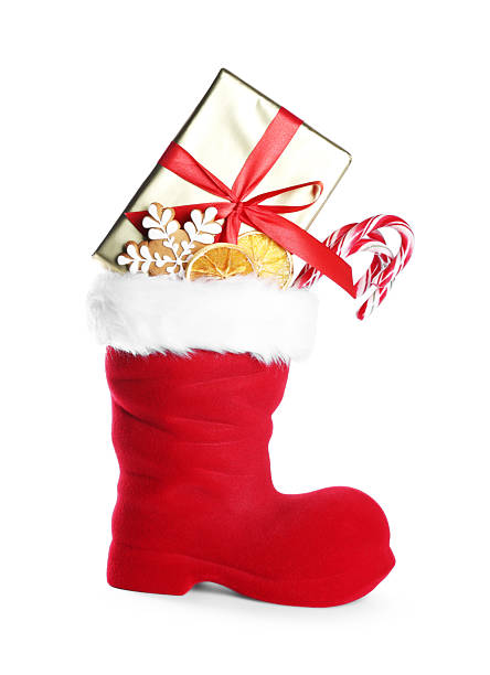 istock Happy Saint Nicholas day. Red boot with sweets and gift box isolated on white 2253114467