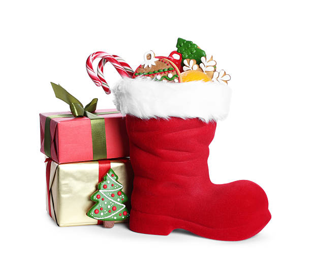 istock Happy Saint Nicholas day. Red boot with sweets and gift boxes isolated on white 2253114479