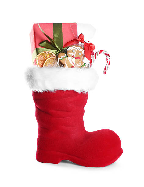 istock Happy Saint Nicholas day. Red boot with sweets and gift box isolated on white 2253114509