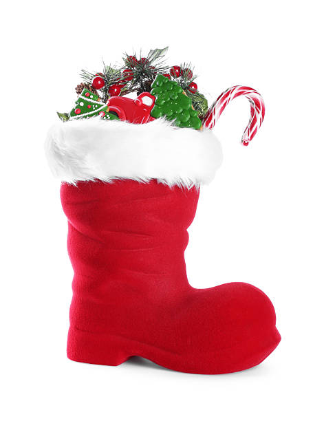 istock Happy Saint Nicholas day. Red boot with sweets and festive decor isolated on white 2253114525