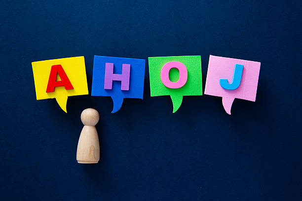 istock Wooden figure communicating greeting ahoj in speech bubbles 2253115329