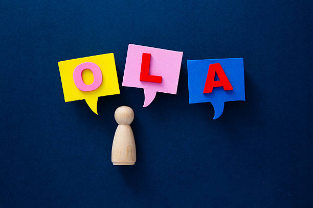 istock Wooden figurine speaking hola in colorful speech bubbles 2253115343