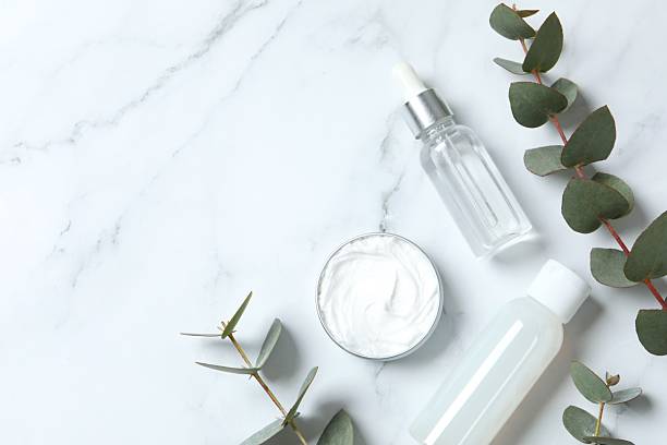 istock Natural cosmetic products with eucalyptus leaves on marble background, top view 2253117776