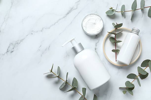 istock Natural cosmetic products with eucalyptus leaves on marble background, top view 2253117809