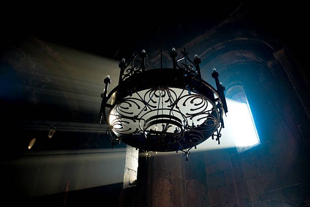 istock Monastery interior. An old lamp in the church. Sunlight streaming through the windows. Christianity and religion. 2253118492