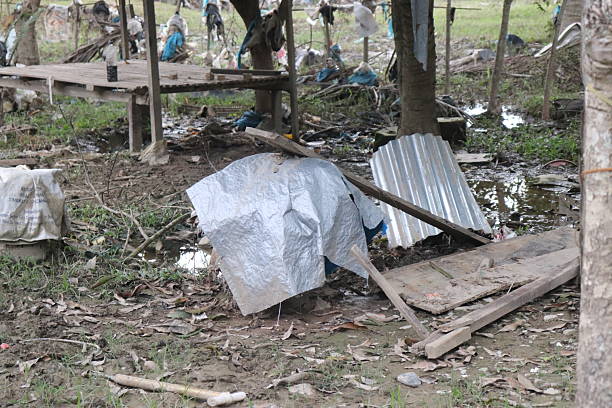istock Makeshift Shelter Surrounded by Rubbish and Mud 2253120244