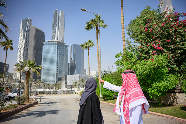 istock Saudi couple pointing at modern Riyadh cityscape 2253120455