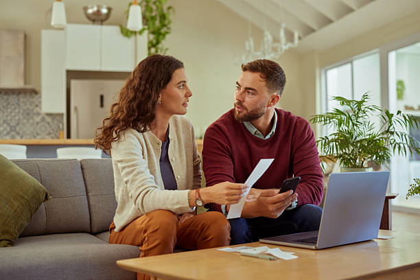 istock Couple discussing bills at home 2253120499