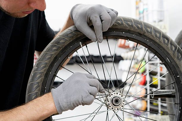 istock A mechanic adjusts bicycle spokes using precise hand movements in a well-equipped workshop. The environment is organized, showcasing tools and bike parts 2253121229
