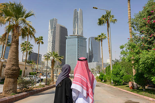 istock Saudi couple admiring modern Riyadh cityscape and palm trees 2253122144