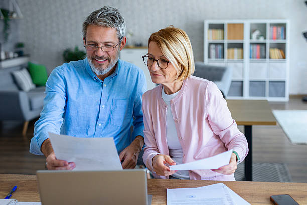 istock Mature Couple Reviewing Retirement Insurance Documents 2253122424