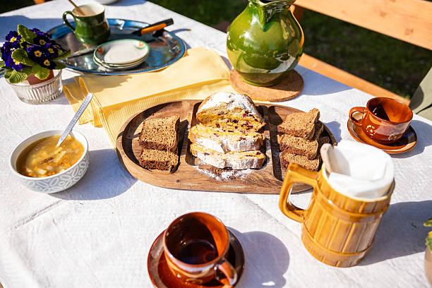 istock Sunlit garden brunch table with fruit loaf, dark rye, and soup 2253123355