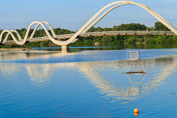 modern bridge architecture object across small river for walking people and place for water polo activity sport playground summer outdoor landscape