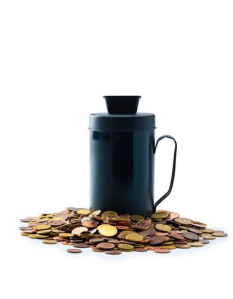 Donating box with international paper money around the jar on a white backdrop. Studio shot.