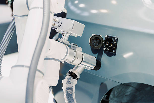 The robotic arm is working in the car factory.