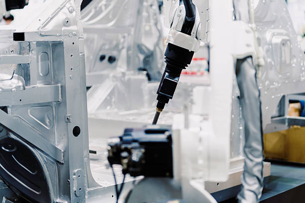 The robotic arm is working in the car factory.