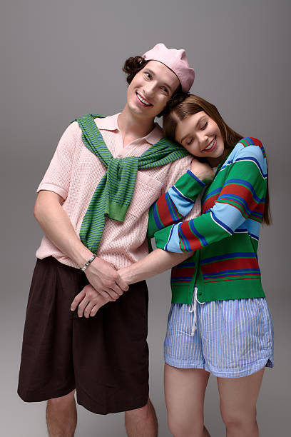 istock Stylish young couple shared a joyful moment in a chic grey studio setting 2253128226
