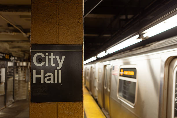 Photo of City Hall subway station with a train arriving on the platform, depicting urban transit and commuting in a metropolitan environment.