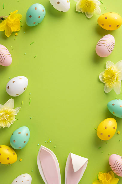 istock Vibrant vertical Easter themed composition featuring pastel eggs, yellow flowers, and a bright green background for seasonal greetings and spring celebration visuals 2253131153