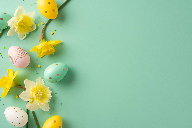 istock Pastel eggs and bright daffodils create a festive Easter scene on a soft green backdrop, conveying greeting, color, and renewal through floral and egg decor 2253131154