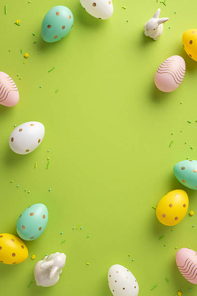 istock Vivid vertical Easter eggs in pastel shades encircle a bright lime background, creating a festive spring scene 2253131160
