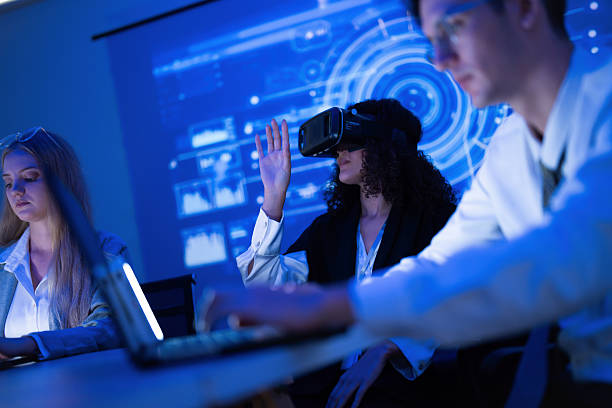 istock Group of young adults engaged in virtual reality experience at tech workshop during evening hours 2253131163
