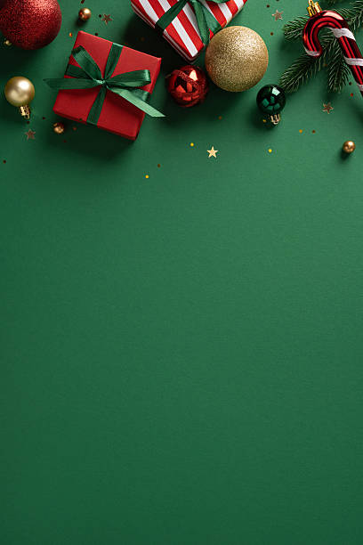 istock Vibrant vertical Christmas gift boxes, baubles, and candy cane decorate a green backdrop, hinting at festive celebrations and New Year greetings 2253131255