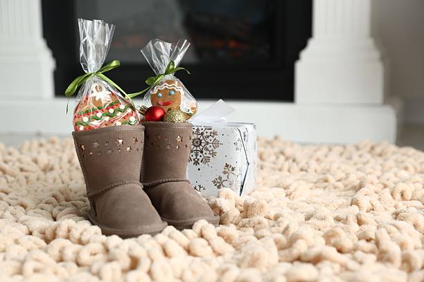 istock Saint Nicholas day tradition. Boots with sweets, baubles and gift box on floor indoors, space for text 2253131822
