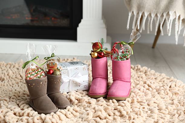 istock Saint Nicholas day tradition. Boots with sweets, festive decor and gift box on floor indoors 2253131823