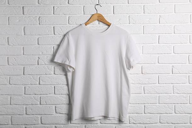 istock Hanger with t-shirt against white brick wall. Mockup for design 2253132014