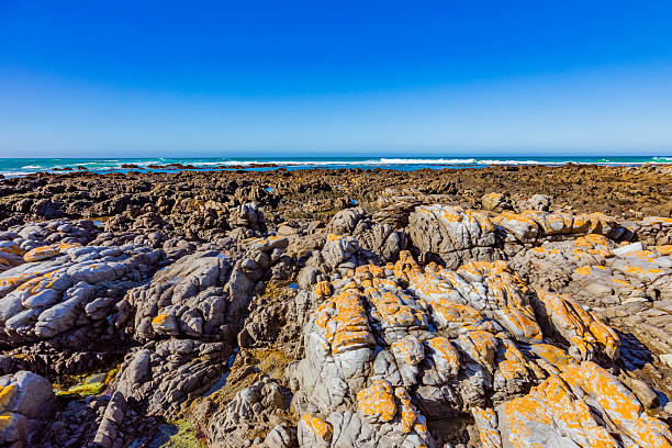 istock Tranquil coastline landscape with azure sky, sand, rocks, and gentle waves 2253133234