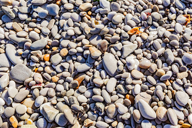 Close up view of small wet pebbles on a beach