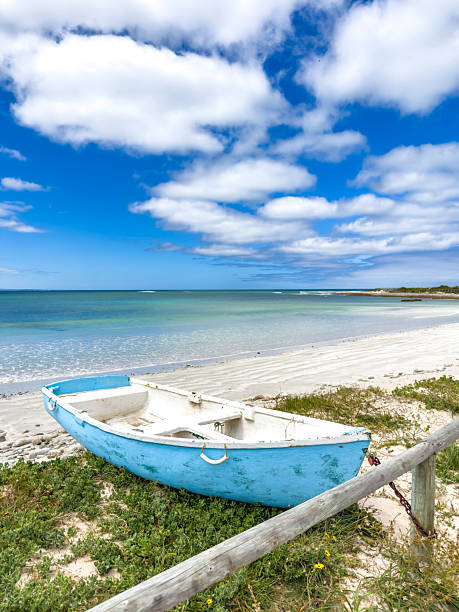 istock Small rowboat dinghy on a beach beneath beautiful blue azure sky 2253133379