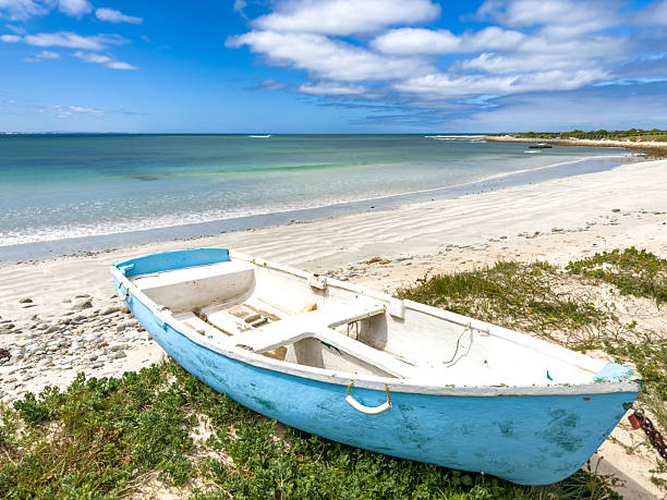 istock Small rowboat dinghy on a beach beneath beautiful blue azure sky 2253133385