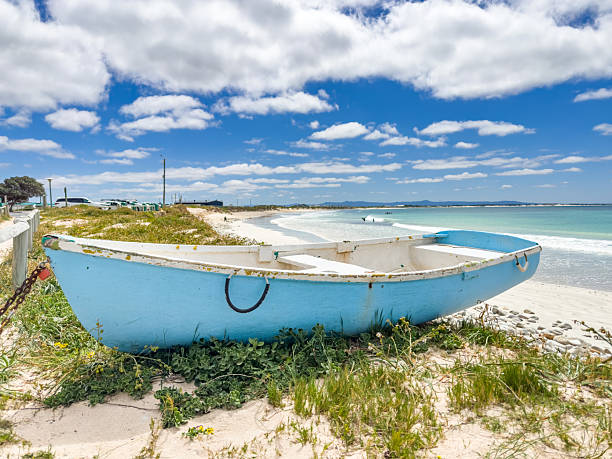 istock Small rowboat dinghy on a beach beneath beautiful blue azure sky 2253133399
