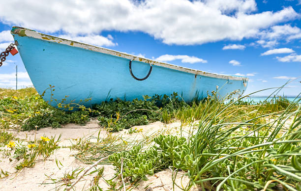 istock Small rowboat dinghy on a beach beneath beautiful blue azure sky 2253133401