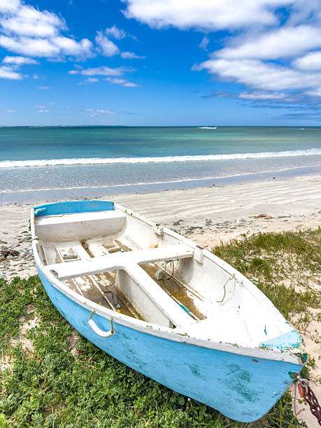 istock Small rowboat dinghy on a beach beneath beautiful blue azure sky 2253133404