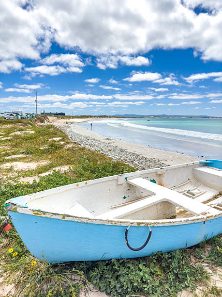 istock Small rowboat dinghy on a beach beneath beautiful blue azure sky 2253133423