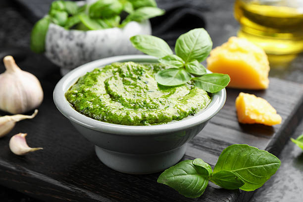istock Fresh pesto sauce and ingredients on black table, closeup 2253133463