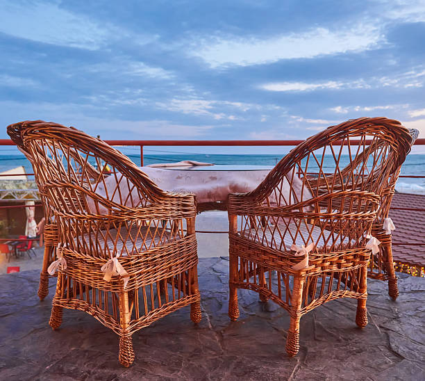A beautiful view of the ocean from the veranda of a snow-white villa located on the shore.