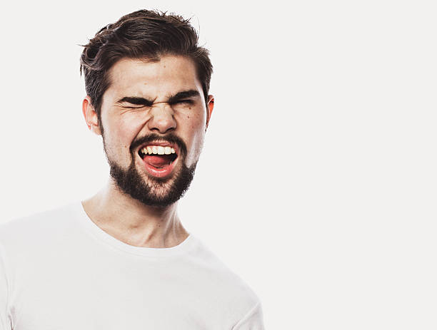 istock Portrait of surprised bearded man against white background 2253134749