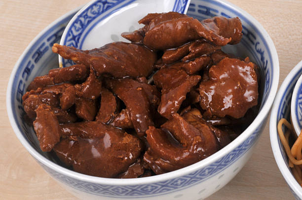 Caramel pork served in a bowl with a spoon close-up